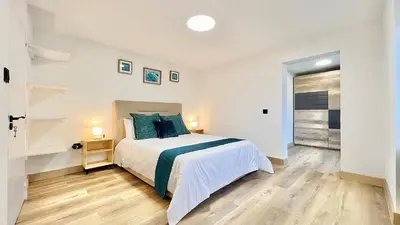 a bedroom with a large bed with blue pillows at The North Paradise - Porto Moniz in Porto Moniz