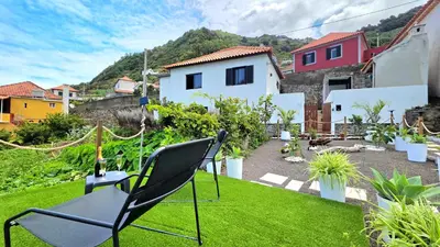 a chair sitting on a lawn in a yard at The North Paradise - Porto Moniz in Porto Moniz