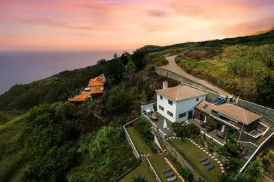 an aerial view of a house on a hill at Meerblick - Exklusives Loft mit Terrassen & Hot-Tub in Fajã da Ovelha