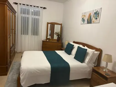 a bedroom with a bed with a microwave on a table at Casa do Pico in Ribeira Brava