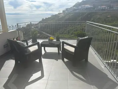 a large body of water with rocks in it at Casa do Pico in Ribeira Brava