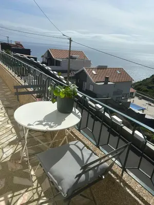 a bedroom with a bed and a dresser and a desk at Casa do Pico in Ribeira Brava