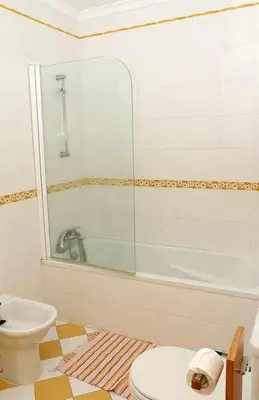 a bathroom with a shower and a toilet and a sink at Magos Sunrise - Apt with sea view in Caniço