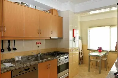a kitchen with a sink and a stove top oven at Magos Sunrise - Apt with sea view in Caniço