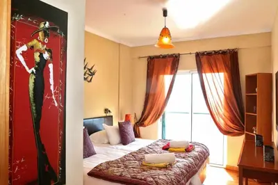 a bedroom with a bed and a window at Magos Sunrise - Apt with sea view in Caniço