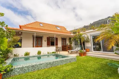 a house with a swimming pool in the yard at Casa das Amoreiras by YMR in Arco da Calheta