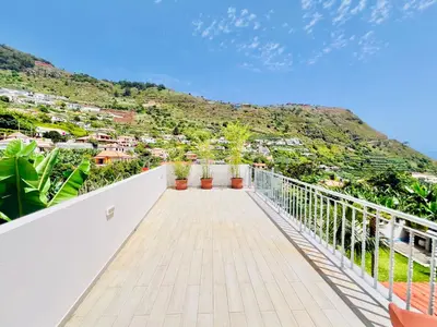 a balcony with a view of a mountain at Casa das Amoreiras by YMR in Arco da Calheta