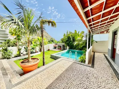 a swimming pool in the backyard of a house at Casa das Amoreiras by YMR in Arco da Calheta