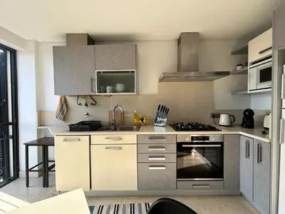 a kitchen with a sink and a stove top oven at Forum Ocean View Apartment 2 in Funchal