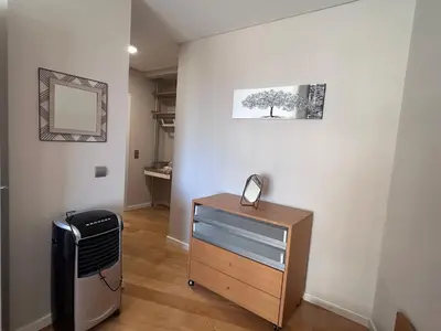 a room with a dresser and a mirror on a wall at Forum Ocean View Apartment 2 in Funchal