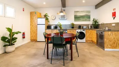 a kitchen with a table and chairs in a room at Modern Tropical Hideaway by LovelyStay in Ponta do Sol