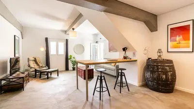 a living room with a table and chairs and a barrel at Modern Tropical Hideaway by LovelyStay in Ponta do Sol