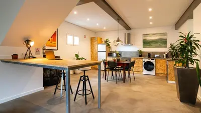 a kitchen and living room with a table and chairs at Modern Tropical Hideaway by LovelyStay in Ponta do Sol