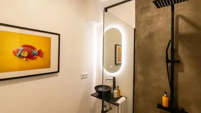 a bathroom with a shower and a painting on the wall at Modern Tropical Hideaway by LovelyStay in Ponta do Sol