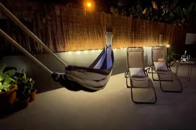 a hammock in a room with two chairs at Modern Tropical Hideaway by LovelyStay in Ponta do Sol