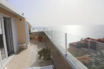 an apartment balcony with a view of the water at Penthouse Ventur in Caniço