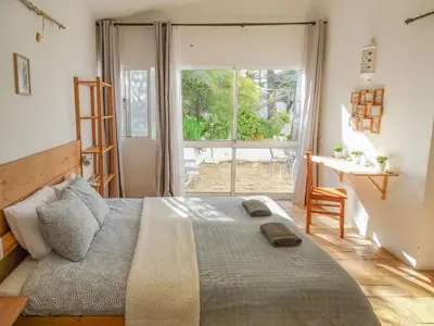 a bedroom with a bed and a large window at Fazenda de Quinta de Lagos in Lagos