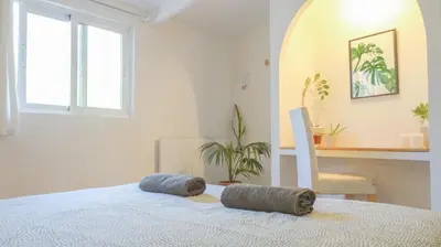 a bedroom with a bed and a table and a chair at Fazenda de Quinta de Lagos in Lagos