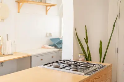 a kitchen with a stove top oven next to a counter at Fazenda de Quinta de Lagos in Lagos