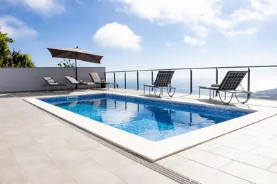 a swimming pool on the roof of a house at Vila Indigo in Arco da Calheta