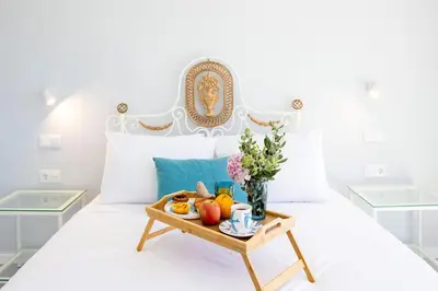 a tray of fruit on a bed with a table at Vila Indigo in Arco da Calheta