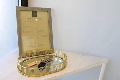 a watch in a gold case on a table with a box at Vila Indigo in Arco da Calheta