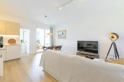 a living room with a couch and a dining room at Bela Vista_Cozy Apt With Sea View in Praia da Arrifana