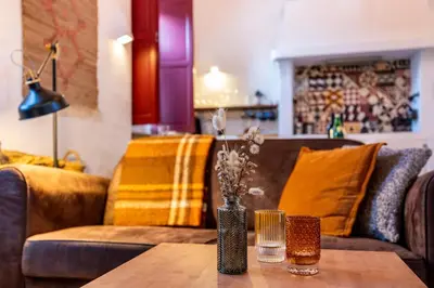 a living room with a couch and a table at Casa dos Cantoneiros in Aljezur