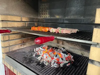 a grill with tongs and food on it at Casa dos Cantoneiros in Aljezur