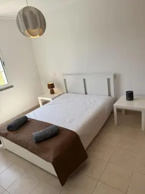 a bedroom with a bed with two pillows on it at Moradia Vitória in Porto Santo