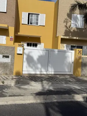 a white fence in front of a house at Moradia Vitória in Porto Santo