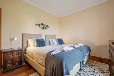 a bedroom with two beds and a night stand at Casa D Agostinha by Homie in Canhas