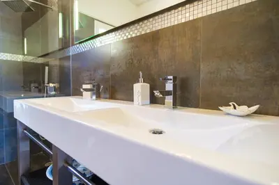 a bathroom with a white sink and a mirror at GuestReady - Spacious stay with sea views in Caniço