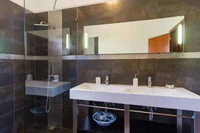 a bathroom with a sink and a mirror at GuestReady - Spacious stay with sea views in Caniço