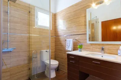 a bathroom with a toilet and a sink and a shower at GuestReady - Spacious stay with sea views in Caniço