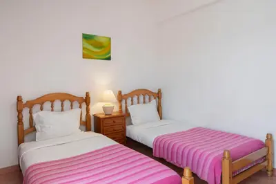 two beds sitting next to each other in a room at Abelisa by An Island Apart in Porto Santo