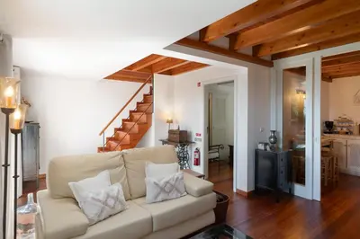 a living room with a couch and a staircase at Casa da Raposeira by An Island Apart in Calheta