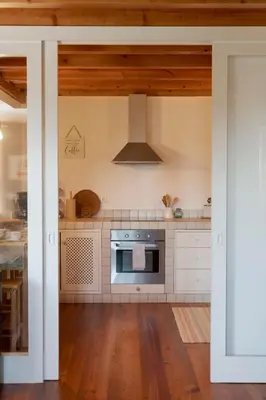 a kitchen with white cabinets and a stove at Casa da Raposeira by An Island Apart in Calheta