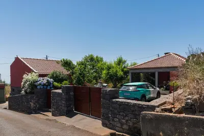 a car parked in front of a house at Casa da Raposeira by An Island Apart in Calheta