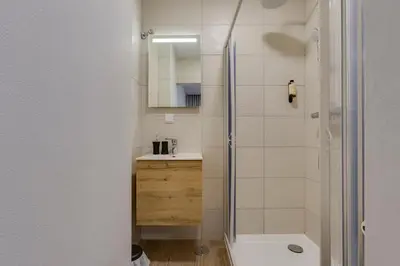 a bathroom with a shower and a toilet and a sink at Refúgio do Cabo in Sagres