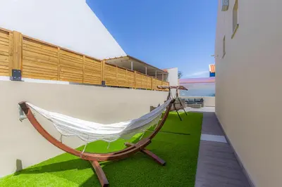 a hammock on the balcony of a house at Refúgio do Cabo in Sagres
