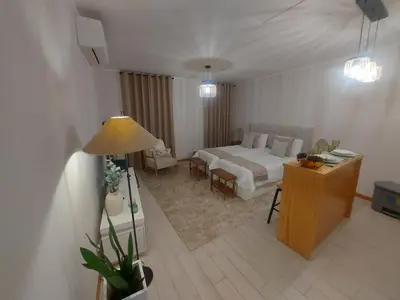a hotel room with a bed and a desk and a room at Seminario Center Apartment in Funchal