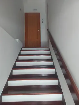 a staircase with a wooden door in a building at Seminario Center Apartment in Funchal