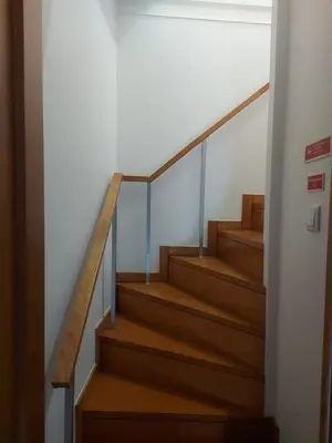 a staircase in a house with wooden stairs at Seminario Center Apartment in Funchal