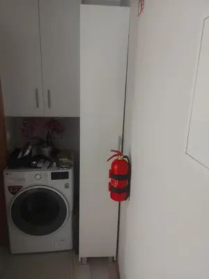 a door to a kitchen with a washing machine at Seminario Center Apartment in Funchal