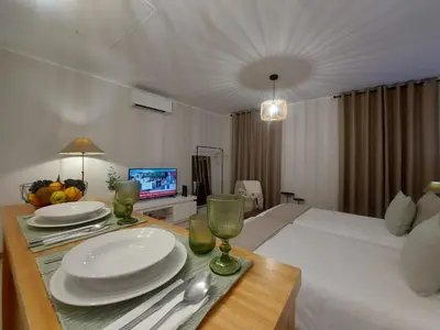 a bedroom with a table with plates and wine glasses at Seminario Center Apartment in Funchal