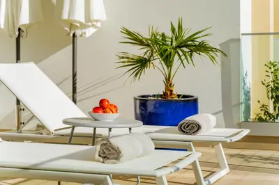 a room with two chairs and a table with towels at ValMar Ocean and Pool View Apartment in Lagos