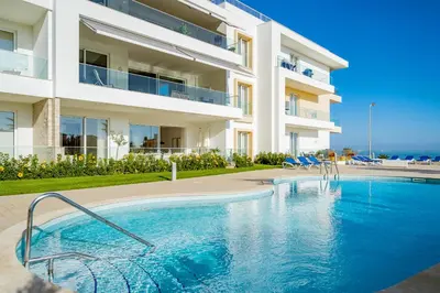 a swimming pool in front of a building at ValMar Ocean and Pool View Apartment in Lagos
