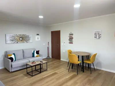 a living room with a couch and a table at Oásis Suites - Funchal in Funchal
