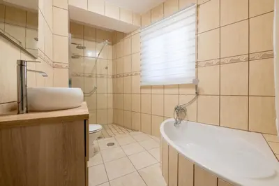 a bathroom with a tub and a toilet and a sink at Casa da Silva home in Funchal in Funchal